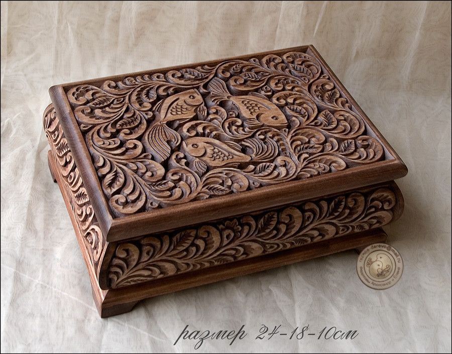 Hand-carved rimu wooden box with intricate koru pattern and smooth finish